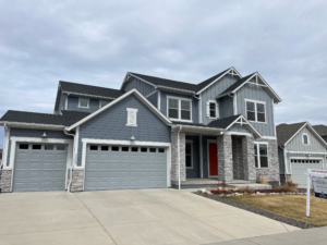 Two-story home for sale in the Denver metro with RE/MAX listing sign in the front yard