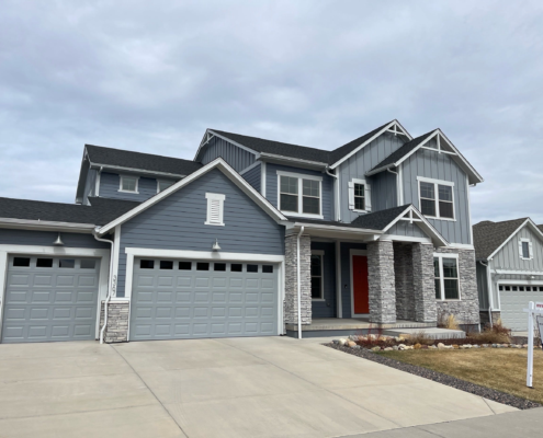 Two-story home for sale in the Denver metro with RE/MAX listing sign in the front yard