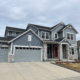 Two-story home for sale in the Denver metro with RE/MAX listing sign in the front yard